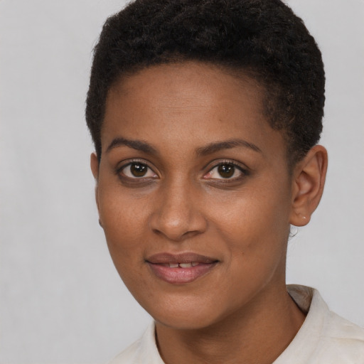 Joyful black young-adult female with short  brown hair and brown eyes