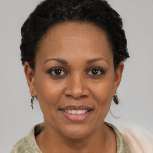 Joyful latino adult female with short  brown hair and brown eyes
