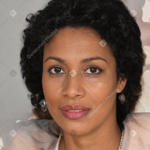 Joyful black young-adult female with long  brown hair and brown eyes