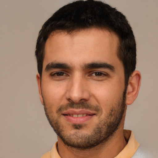 Joyful white young-adult male with short  black hair and brown eyes