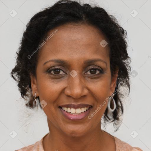 Joyful black adult female with short  brown hair and brown eyes