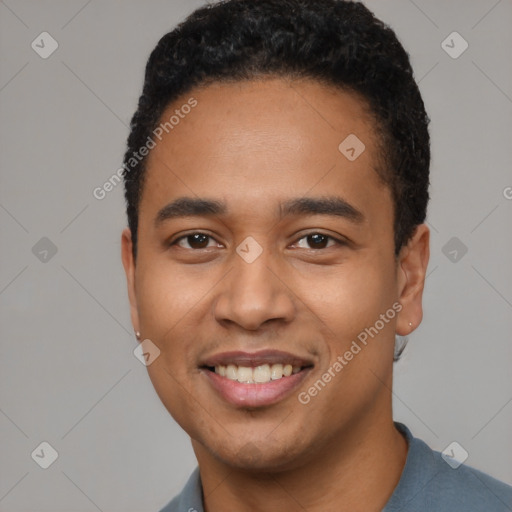 Joyful latino young-adult male with short  black hair and brown eyes