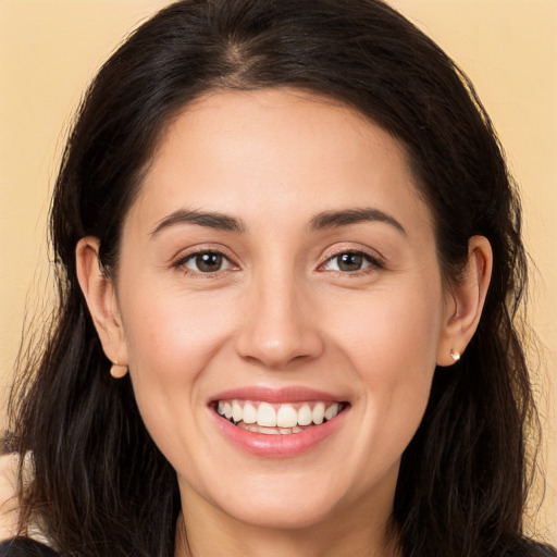 Joyful white young-adult female with long  brown hair and brown eyes