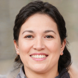 Joyful white adult female with medium  brown hair and brown eyes