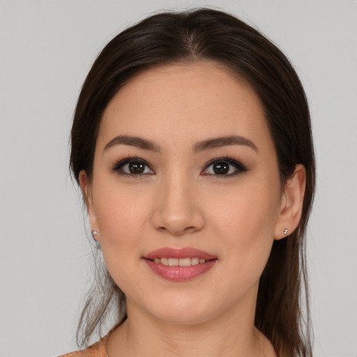 Joyful latino young-adult female with medium  brown hair and brown eyes