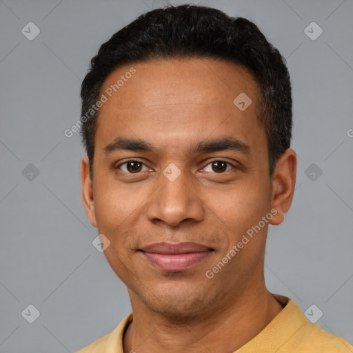 Joyful latino young-adult male with short  black hair and brown eyes