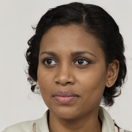 Joyful black young-adult female with medium  brown hair and brown eyes