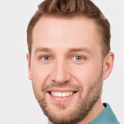 Joyful white young-adult male with short  brown hair and blue eyes