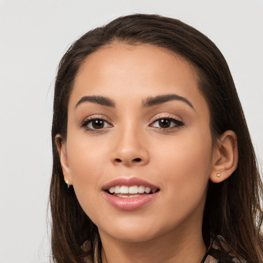 Joyful white young-adult female with long  brown hair and brown eyes