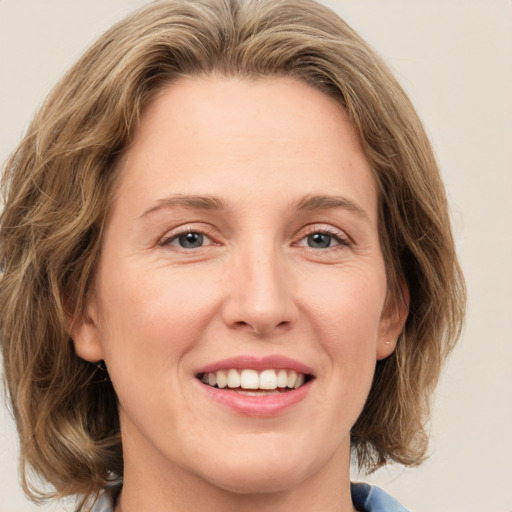 Joyful white young-adult female with medium  brown hair and green eyes