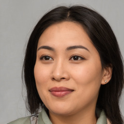 Joyful asian young-adult female with long  brown hair and brown eyes