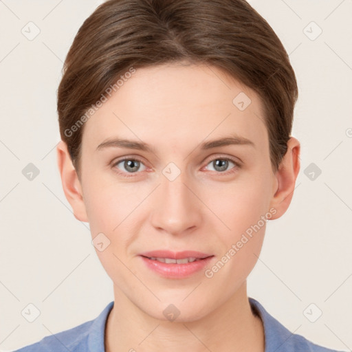 Joyful white young-adult female with short  brown hair and grey eyes