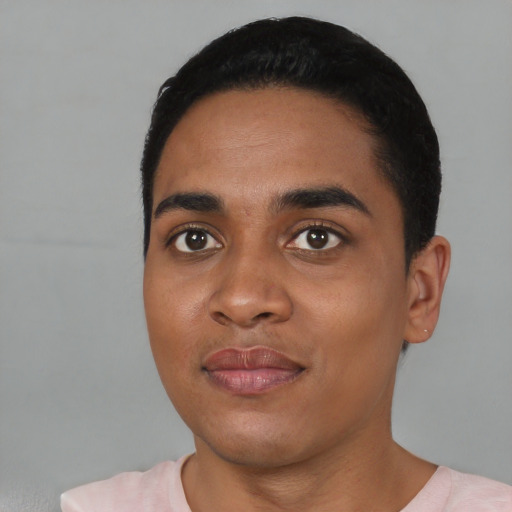 Joyful black young-adult male with short  black hair and brown eyes