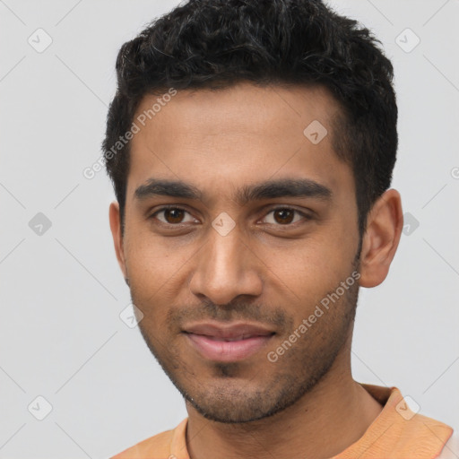 Joyful latino young-adult male with short  brown hair and brown eyes