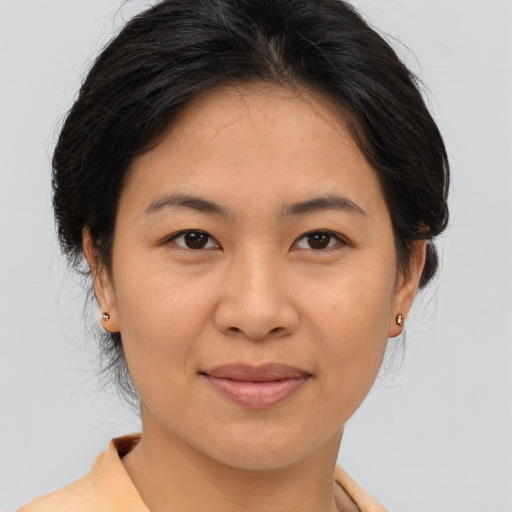Joyful asian young-adult female with medium  brown hair and brown eyes
