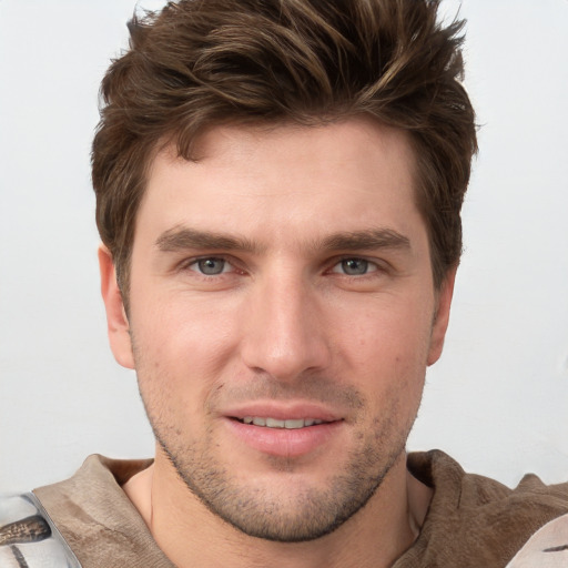 Joyful white young-adult male with short  brown hair and grey eyes