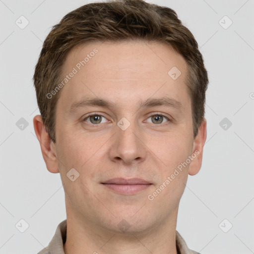 Joyful white young-adult male with short  brown hair and grey eyes