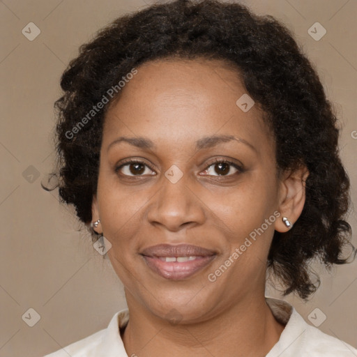 Joyful black adult female with medium  brown hair and brown eyes