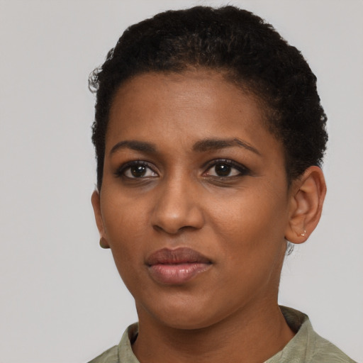 Joyful black young-adult female with short  black hair and brown eyes