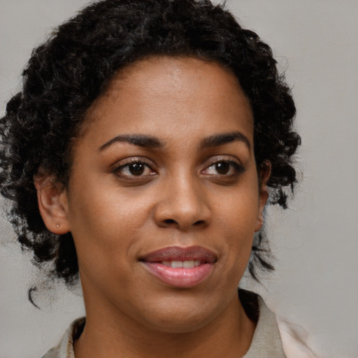 Joyful black young-adult female with medium  brown hair and brown eyes