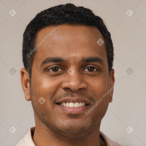Joyful black young-adult male with short  black hair and brown eyes