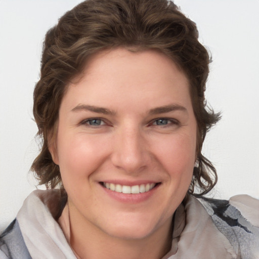 Joyful white young-adult female with medium  brown hair and blue eyes