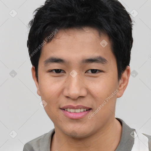 Joyful asian young-adult male with short  black hair and brown eyes