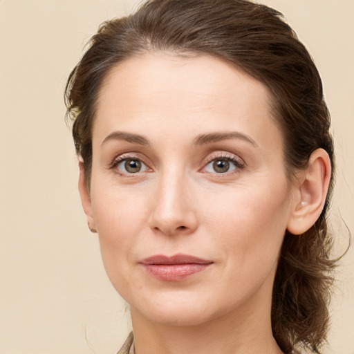 Joyful white young-adult female with long  brown hair and grey eyes