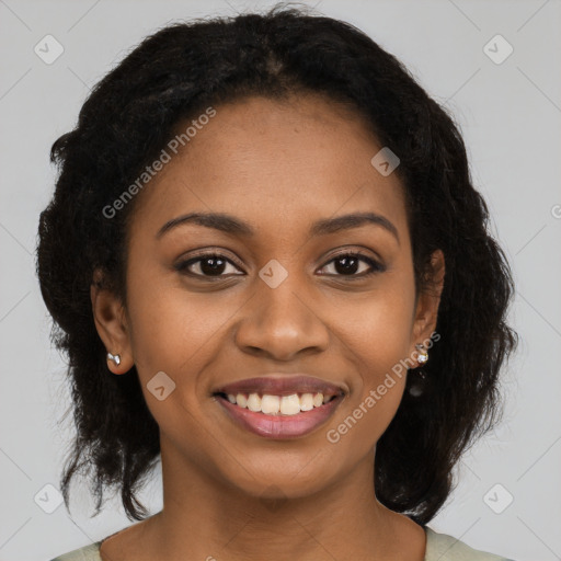 Joyful black young-adult female with long  brown hair and brown eyes