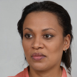 Joyful black young-adult female with medium  brown hair and brown eyes