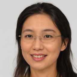 Joyful white adult female with long  brown hair and brown eyes