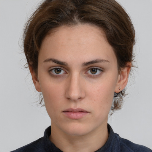 Neutral white young-adult female with short  brown hair and brown eyes