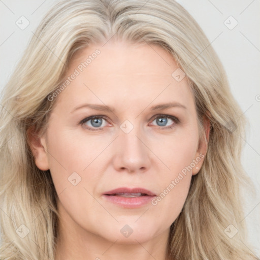 Joyful white adult female with long  brown hair and blue eyes