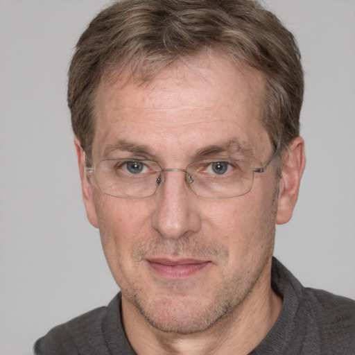 Joyful white middle-aged male with short  brown hair and grey eyes