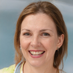 Joyful white adult female with medium  brown hair and brown eyes