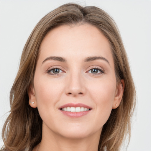 Joyful white young-adult female with long  brown hair and grey eyes