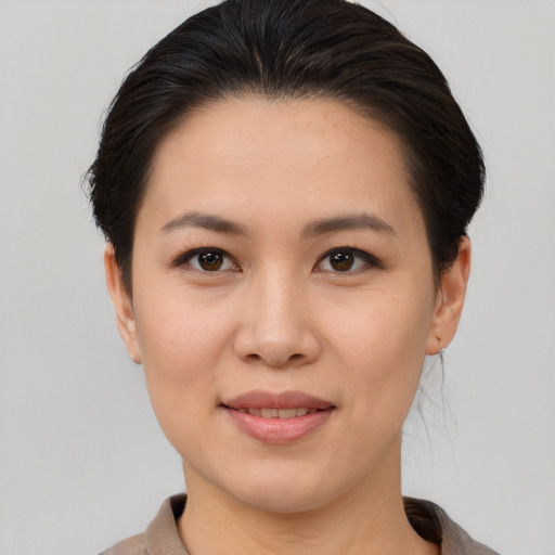 Joyful asian young-adult female with medium  brown hair and brown eyes