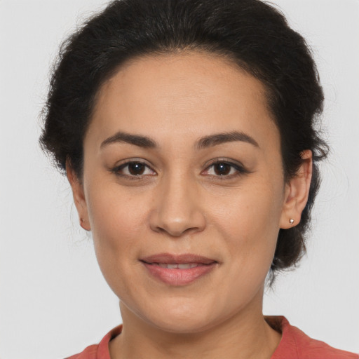 Joyful latino young-adult female with medium  brown hair and brown eyes