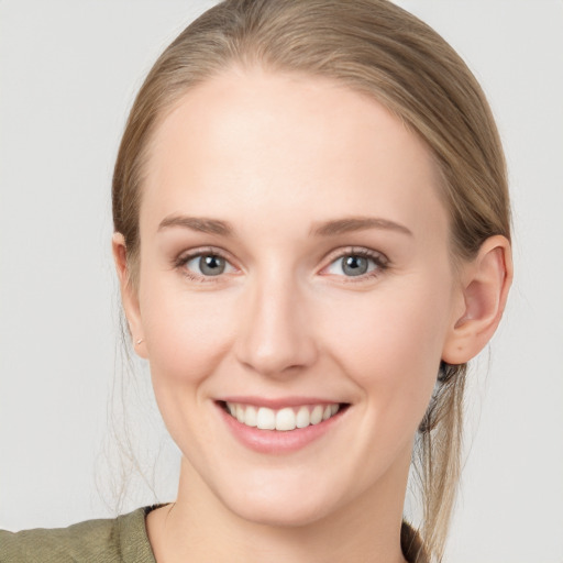 Joyful white young-adult female with medium  brown hair and blue eyes