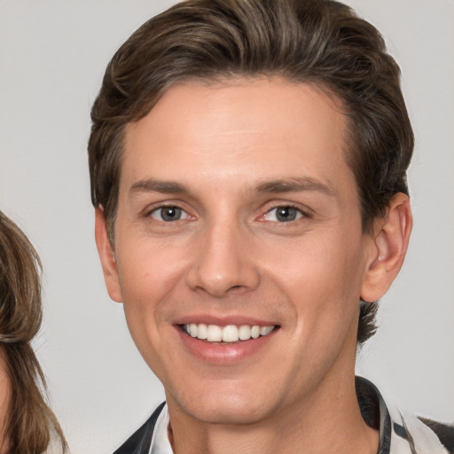 Joyful white young-adult male with medium  brown hair and brown eyes