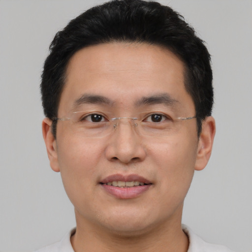 Joyful asian young-adult male with short  brown hair and brown eyes