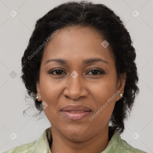 Joyful black adult female with medium  brown hair and brown eyes