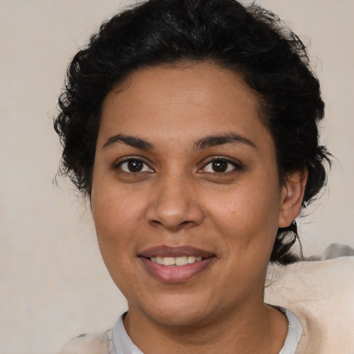 Joyful latino adult female with medium  brown hair and brown eyes