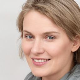 Joyful white young-adult female with medium  brown hair and blue eyes