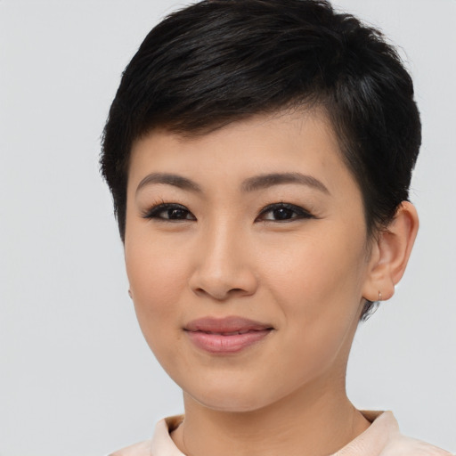 Joyful asian young-adult female with short  brown hair and brown eyes
