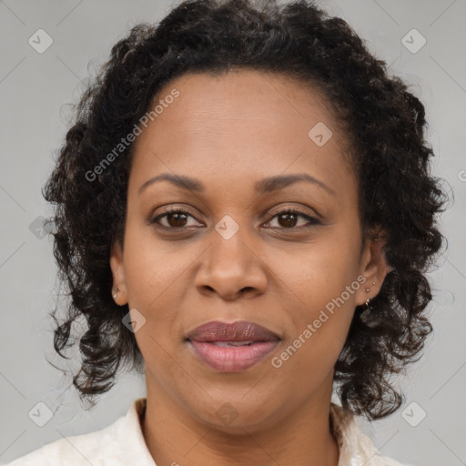 Joyful black adult female with medium  brown hair and brown eyes