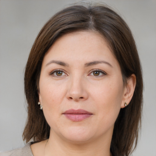 Joyful white adult female with medium  brown hair and brown eyes