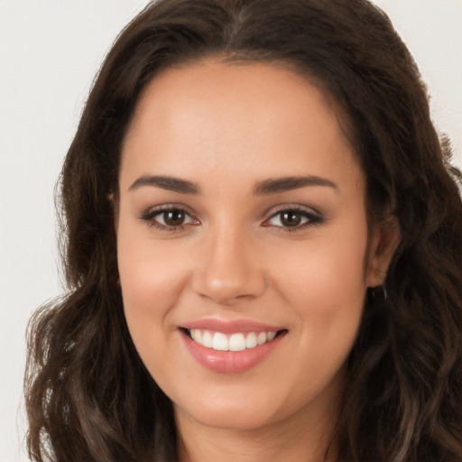 Joyful white young-adult female with long  brown hair and brown eyes