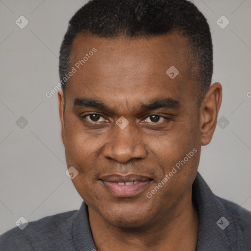 Joyful black adult male with short  brown hair and brown eyes