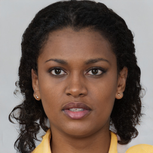Neutral black young-adult female with long  brown hair and brown eyes